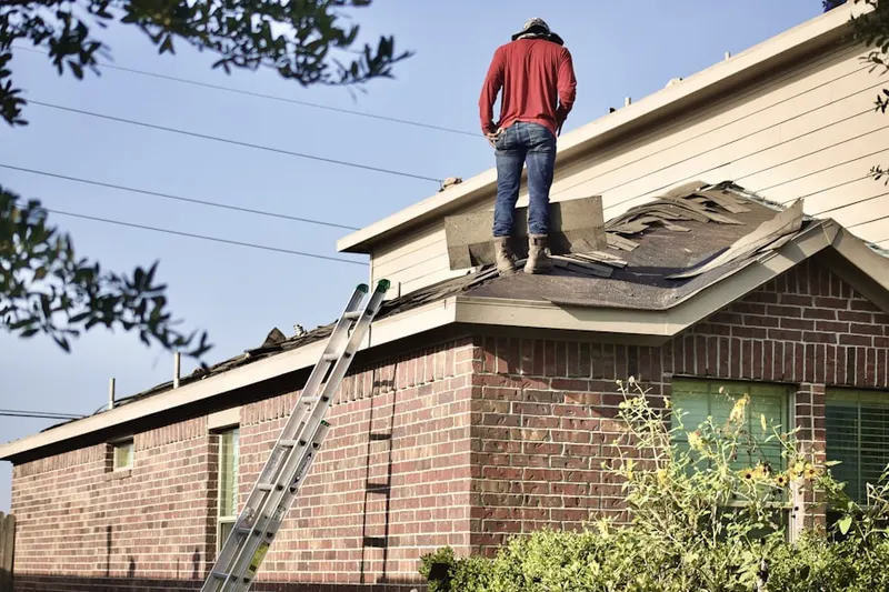 Professional roofer working on a residential roof in West Bridgewater